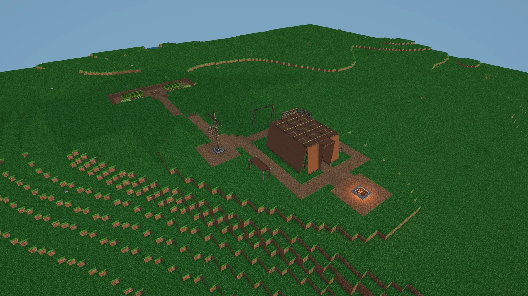 An overhead view of a Versalox camp and surrounding voxel landscape